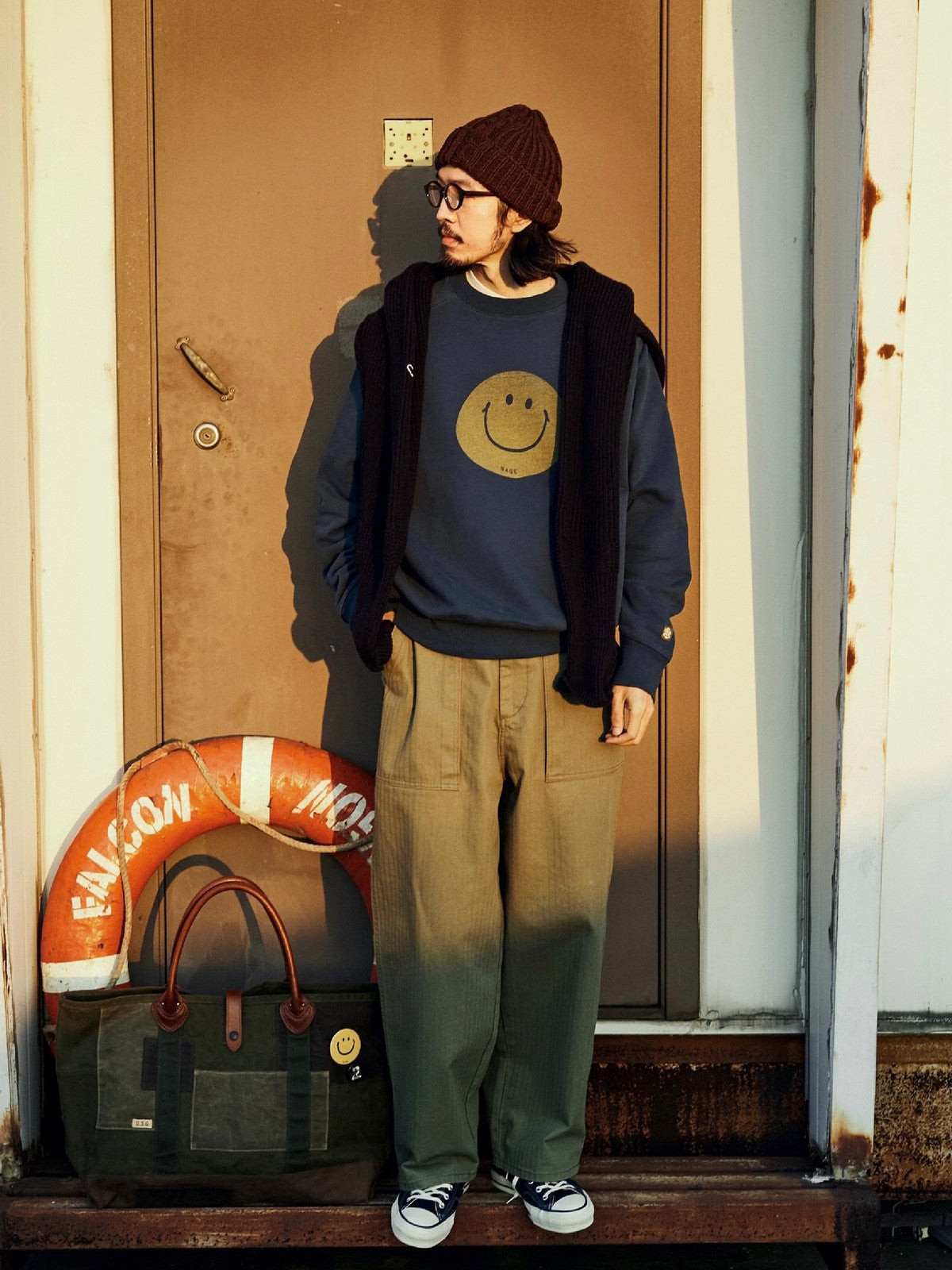 USAGE Washed Cotton Raglan Smiley Sweatshirt in Blue - On Male Model