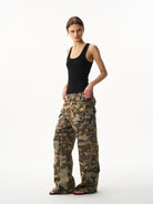 BLINDNOPLAN Paneled Camo Flared Cargo Pants in Green - On Female Model