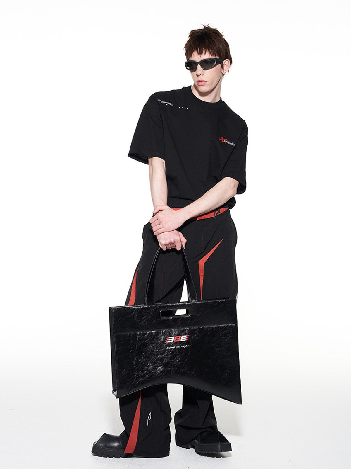 BLINDNOPLAN Textured Faux Leather Asymmetric Tote in Black - On Male Model