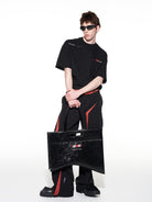 BLINDNOPLAN Textured Faux Leather Asymmetric Tote in Black - On Male Model