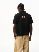BLINDNOPLAN Distressed Embroidered Cotton Polo in Black - On Model