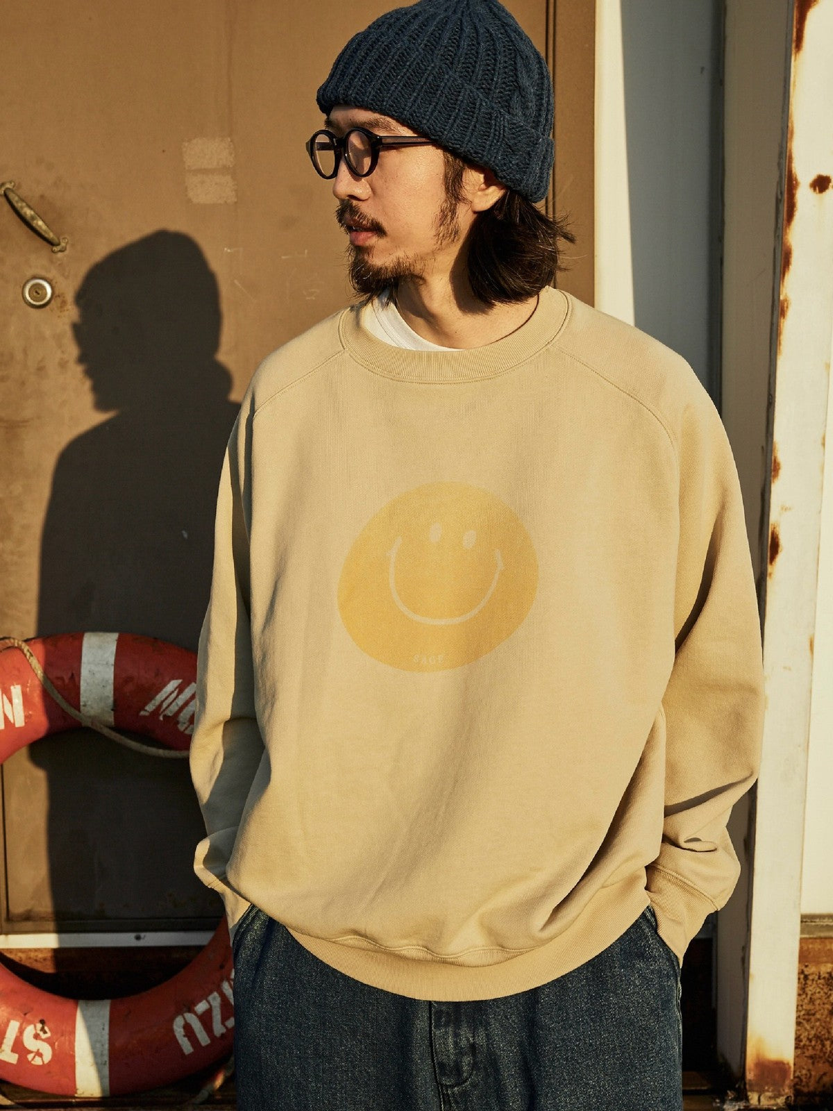 USAGE Washed Cotton Raglan Smiley Sweatshirt in Beige - On Male Model