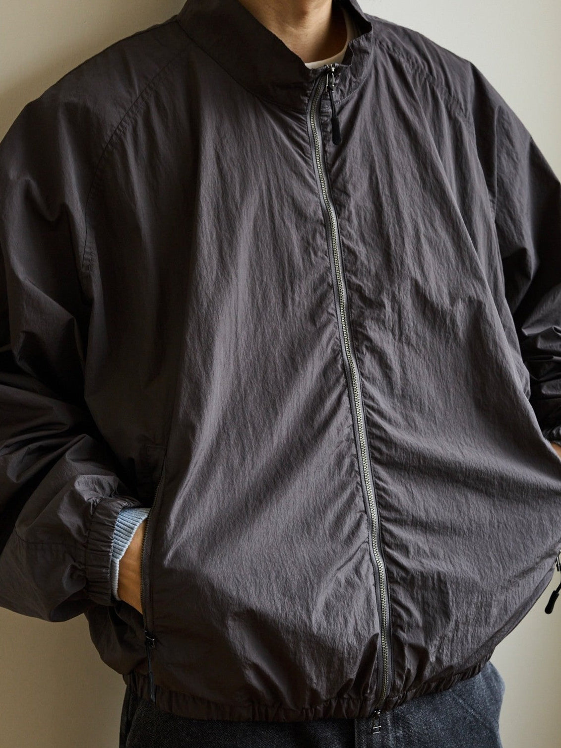 USAGE Lightweight Nylon Zip Up Jacket in Gray - On Male Model
