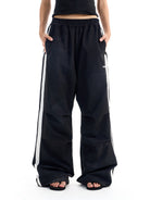 BLINDNOPLAN Striped Pleated Track Pants in Black - On Female Model