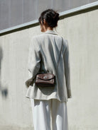 QIUZHEN Vintage Leather Envelope Crossbody in Dark Brown - On Female Model