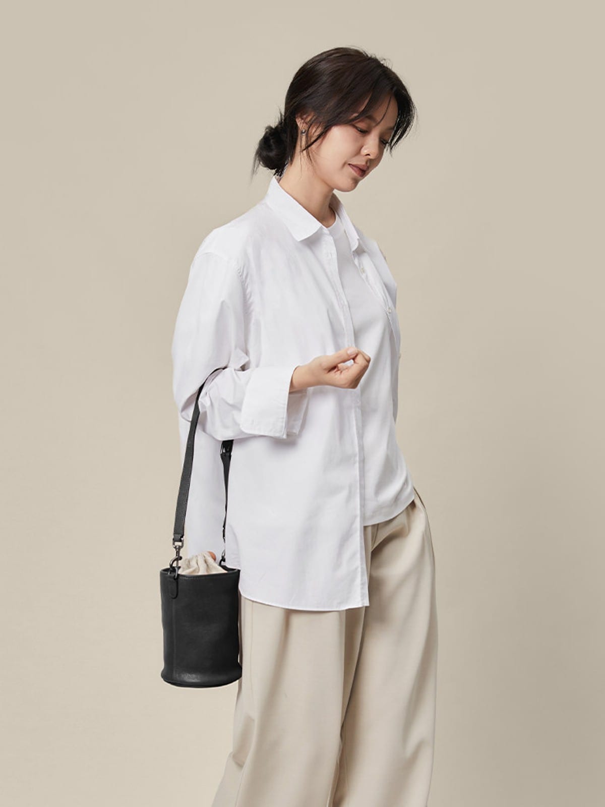 QIUZHEN Leather Drawstring Bucket Bag in Black - On Female Model