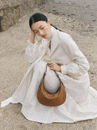 QIUZHEN Vegetable Tanned Leather Crescent Bag in Beige - On Female Model