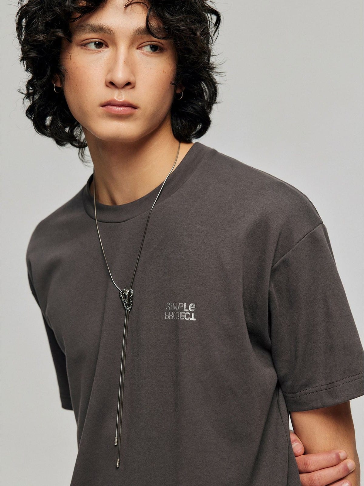 SIMPLE PROJECT Inverted Silver Logo Crewneck T Shirt in Charcoal - On Male Model