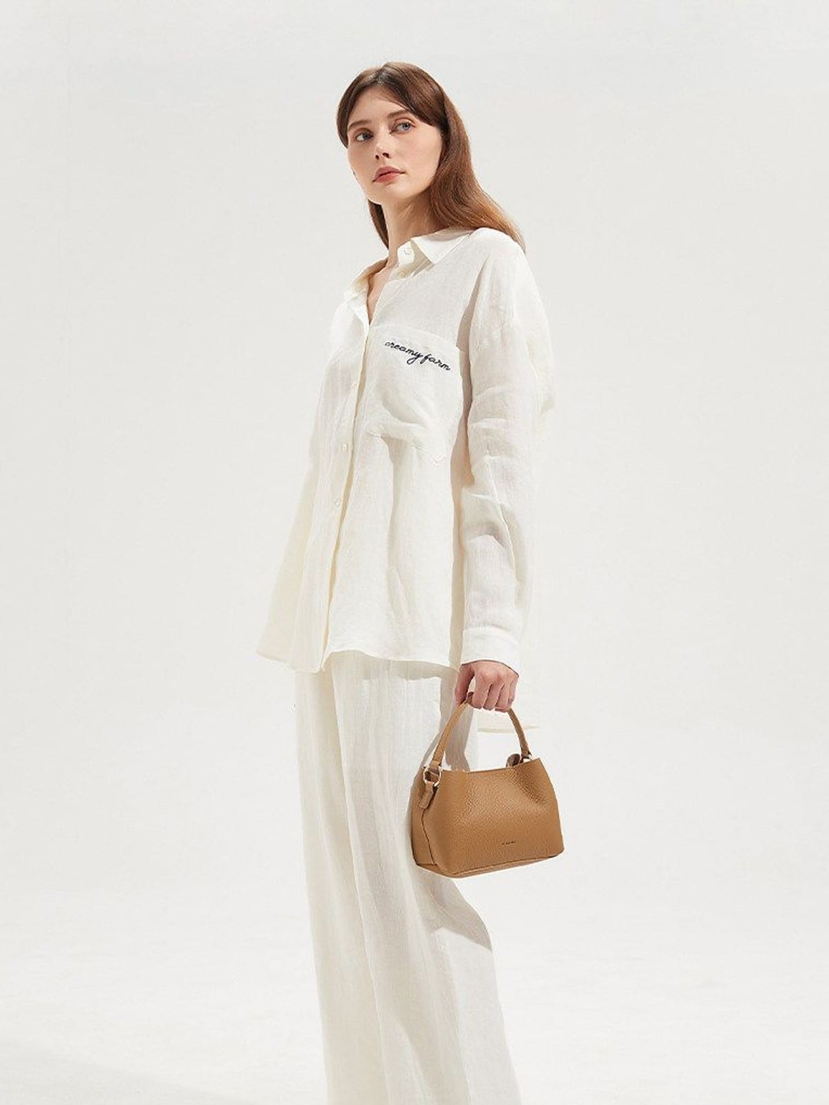 HONGU Cowhide Crossbody Bucket Bag in Taupe - On Female Model