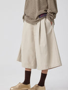 SIMPLE PROJECT Cotton Pleated Cropped Shorts in Beige - On Model