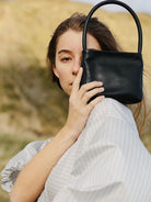 PANLULUPAN Waxed Cowhide Square Shoulder Bag in Black - On Female Model
