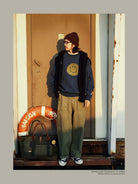 USAGE Washed Cotton Raglan Smiley Sweatshirt in Blue - On Male Model