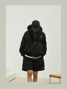 USAGE Crinkle Nylon Hooded Track Jacket in Black - On Male Model