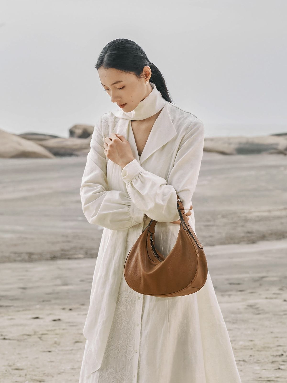 QIUZHEN Vegetable Tanned Leather Crescent Bag in Beige - On Female Model