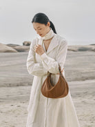QIUZHEN Vegetable Tanned Leather Crescent Bag in Beige - On Female Model