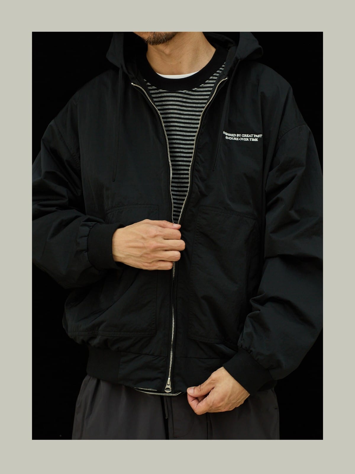 USAGE Crinkle Nylon Hooded Track Jacket in Black - On Male Model