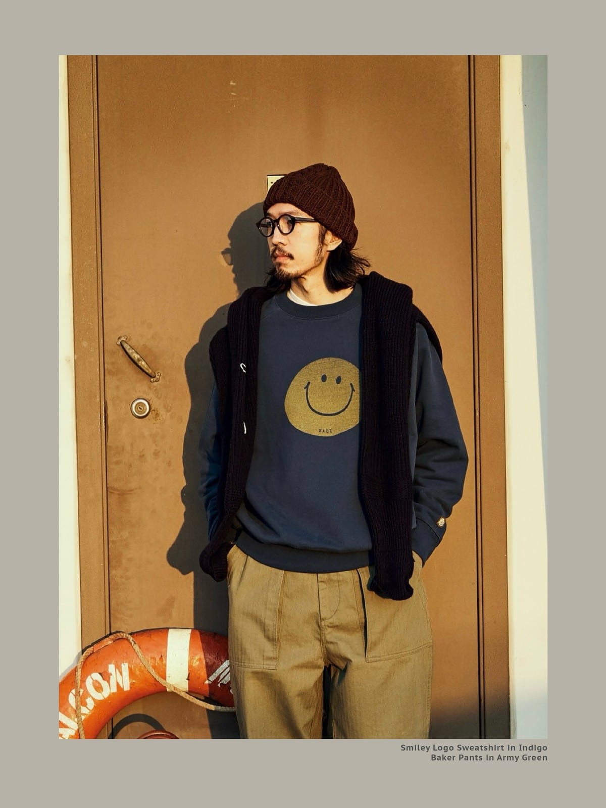USAGE Washed Cotton Raglan Smiley Sweatshirt in Blue - On Male Model