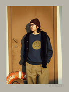 USAGE Washed Cotton Raglan Smiley Sweatshirt in Blue - On Male Model