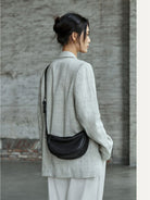 QIUZHEN Vegetable Tanned Leather Crescent Bag in Black - On Female Model