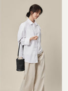 QIUZHEN Leather Drawstring Bucket Bag in Black - On Female Model