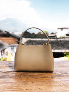 HONGU Cowhide Crossbody Bucket Bag in Taupe - Lifestyle