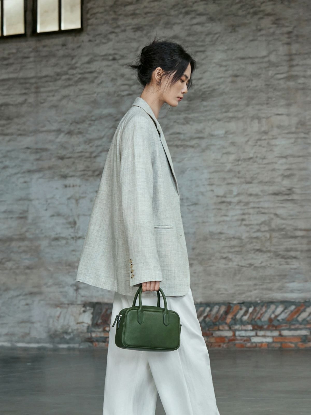 QIUZHEN Vegetable Tanned Leather Bowling Bag in Green - On Female Model