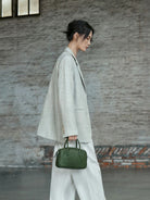 QIUZHEN Vegetable Tanned Leather Bowling Bag in Green - On Female Model
