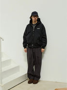 USAGE Crinkle Nylon Hooded Track Jacket in Black - On Male Model