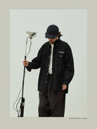 USAGE Oversized Micro Check Button Down Shirt in Black - On Male Model