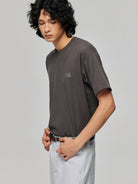 SIMPLE PROJECT Inverted Silver Logo Crewneck T Shirt in Charcoal - On Male Model