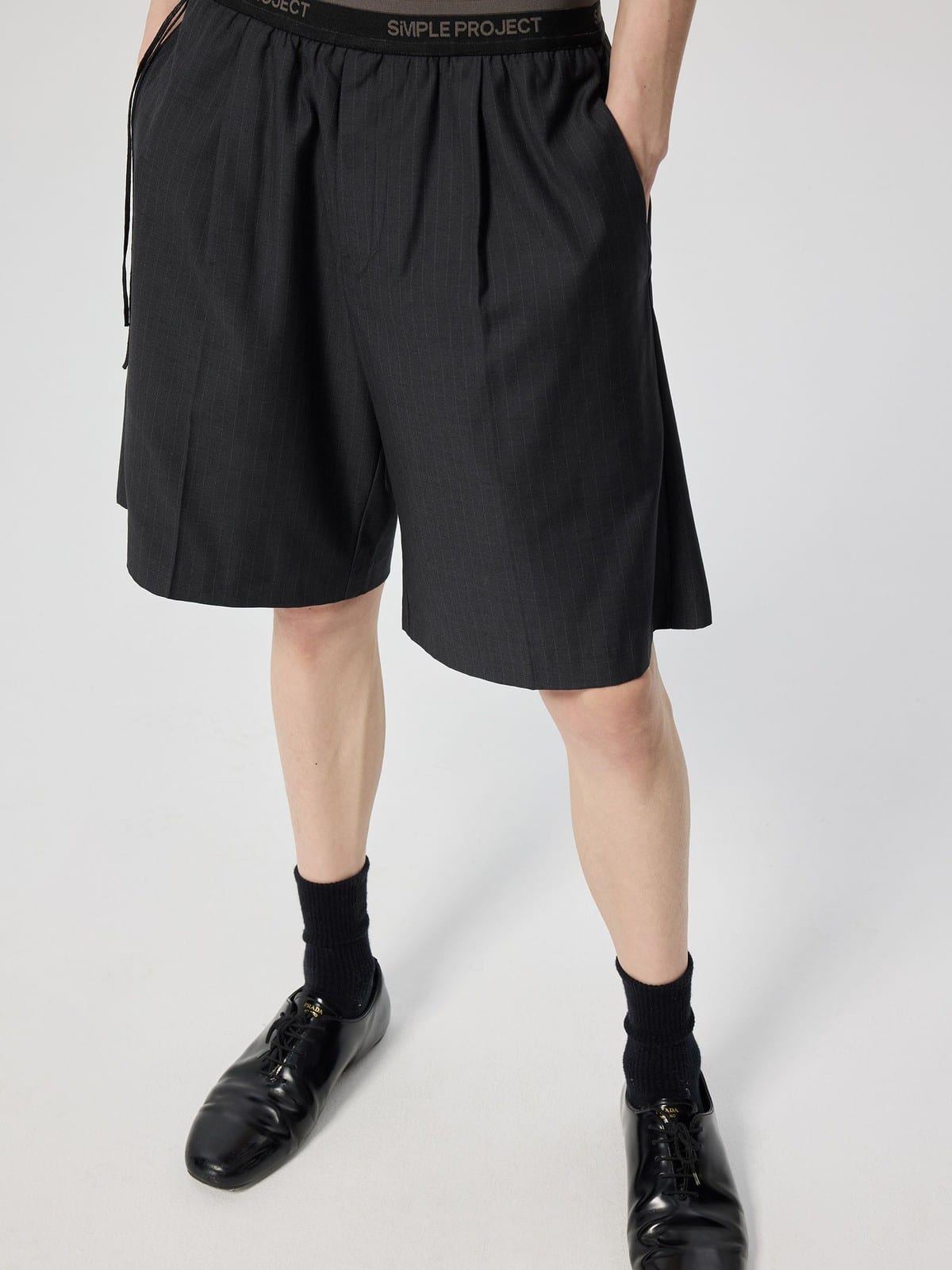 SIMPLE PROJECT Logo Tape Wool Blend Shorts in Gray - On Model