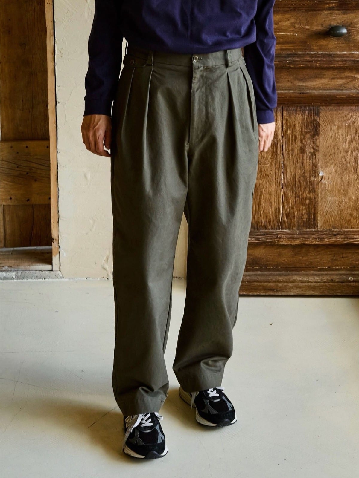 USAGE Pleated Cotton Twill Chinos in Olive - On Male Model