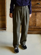 USAGE Pleated Cotton Twill Chinos in Olive - On Male Model