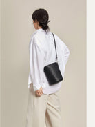 QIUZHEN Leather Drawstring Bucket Bag in Black - On Female Model