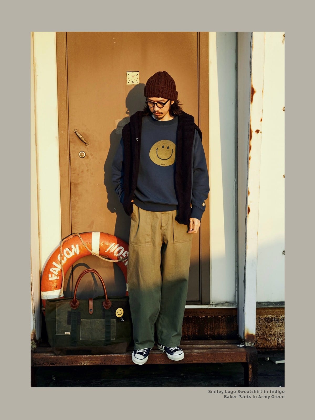 USAGE Washed Cotton Raglan Smiley Sweatshirt in Blue - On Male Model