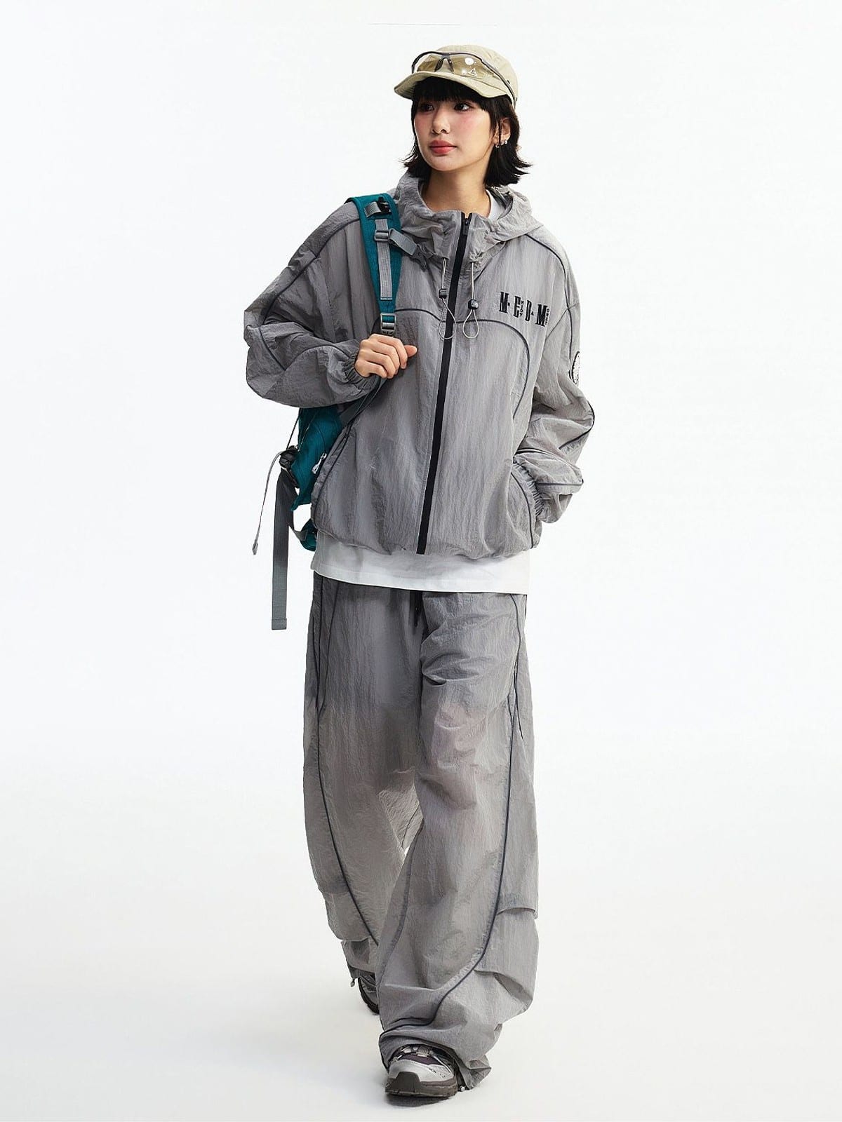 MEDM Glossy Piped Techwear Track Pants in Light Gray - On Female Model