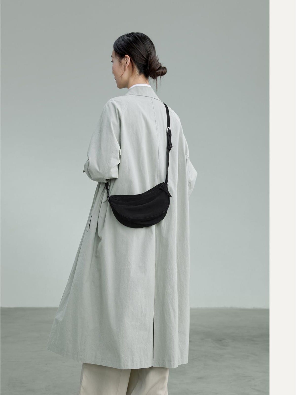 QIUZHEN Vegetable Tanned Leather Crescent Bag in Black - On Female Model