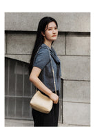 HONGU Cowhide Crossbody Bucket Bag in Beige - On Female Model