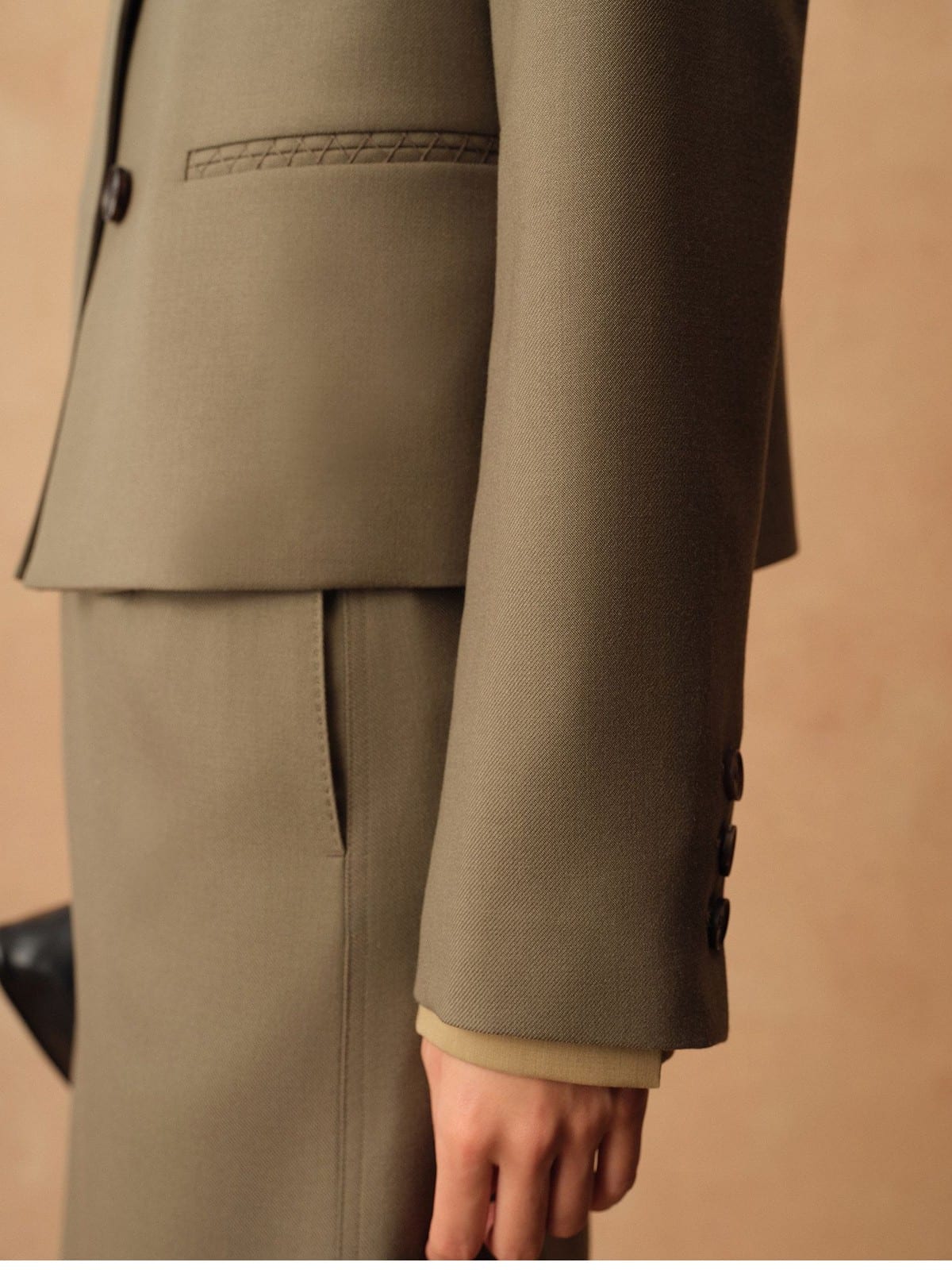 TEASEL Merino Wool Pleated Trousers in Olive - On Model