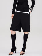 RARELY ALIKE Tailored Bermuda Shorts in Black - On Female Model