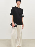 MSBEAST Oversized Acetate Satin T Shirt in Black - On Female Model