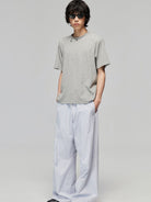 SIMPLE PROJECT Textured Diagonal Paneled T Shirt in Heather Gray - On Male Model