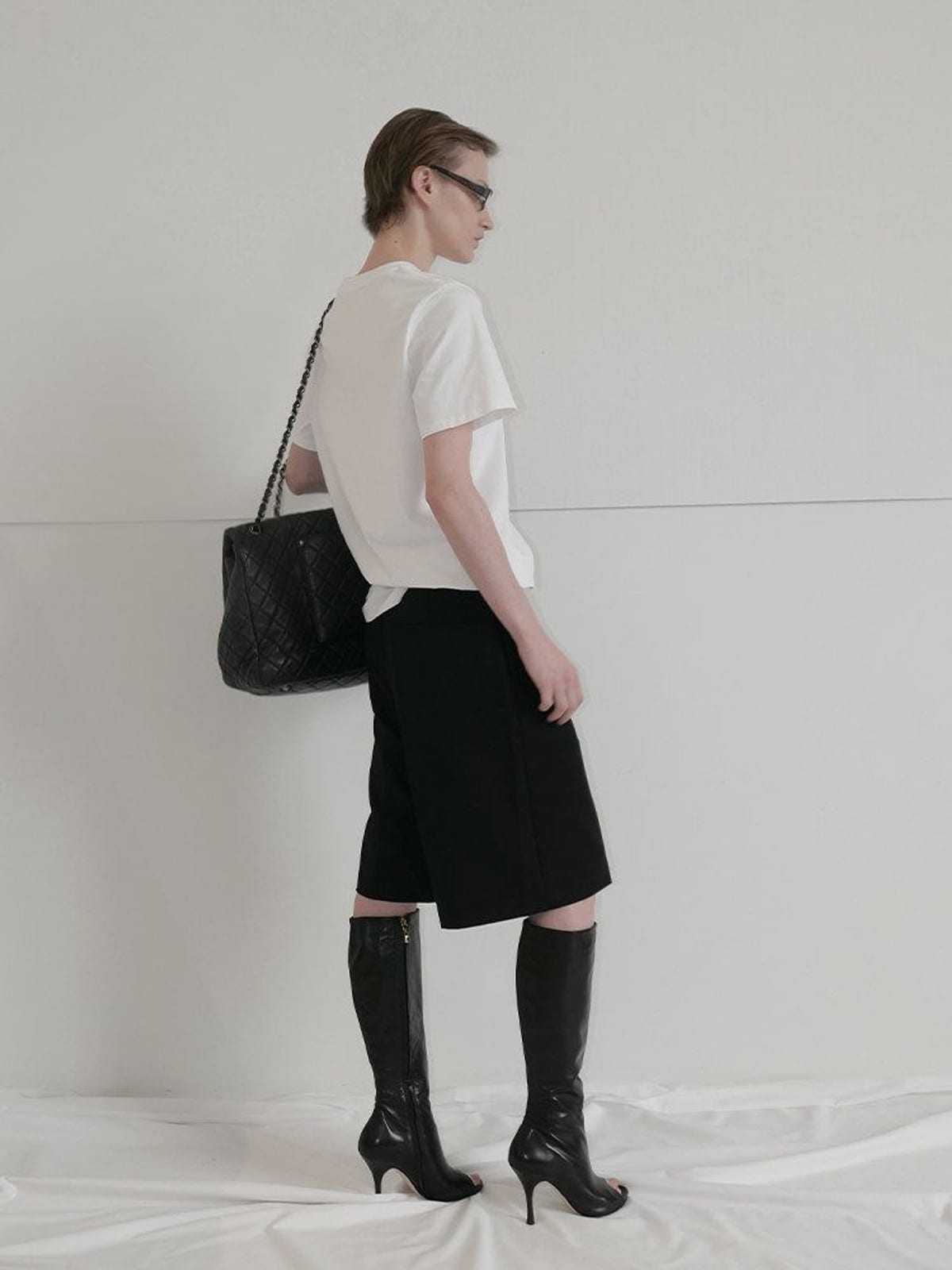 RARELY ALIKE Tailored Bermuda Shorts in Black - On Model