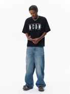 MEDM Vintage Logo Typography Cotton T Shirt in Black - On Male Model