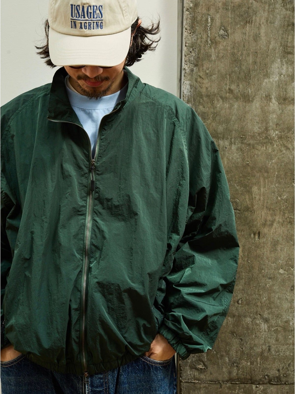 USAGE Lightweight Nylon Zip Up Jacket in Green - On Male Model