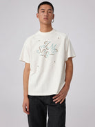 SIMPLE PROJECT Brass Stud Retro Logo Cotton T Shirt in White - On Male Model