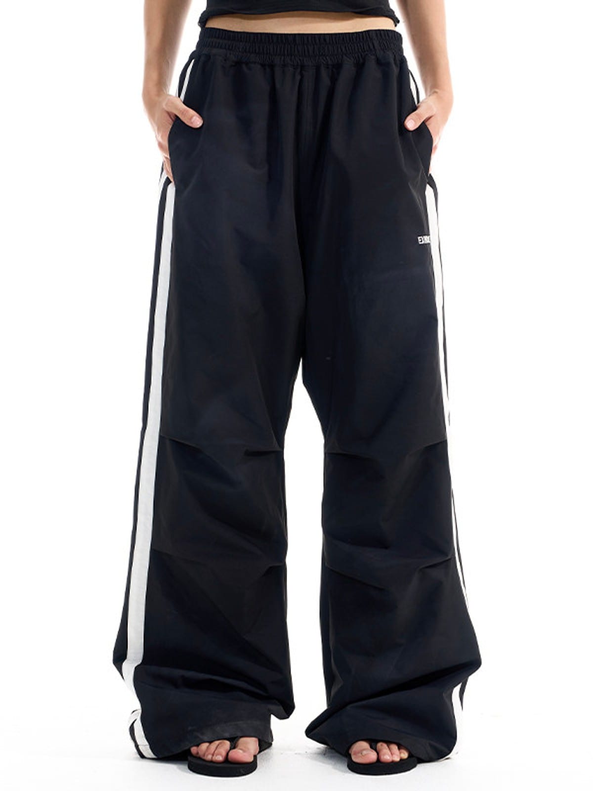 BLINDNOPLAN Striped Pleated Track Pants in Black - On Model