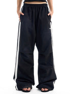 BLINDNOPLAN Striped Pleated Track Pants in Black - On Model