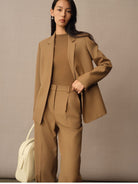 TEASEL Merino Wool Pleated Trousers in Brown - On Female Model
