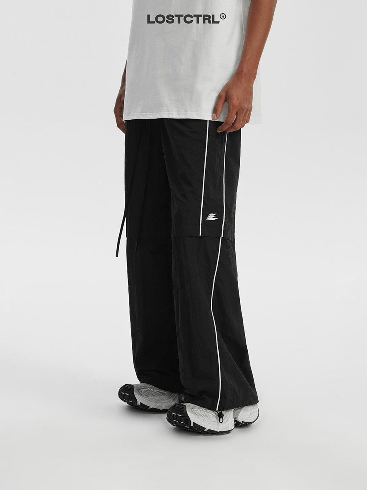 LOSTCTRL Contrast Piping Nylon Trousers in Black - On Male Model